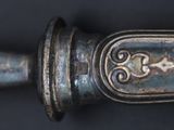 a close up of a metal object on a black surface
