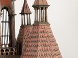 a bird cage with a clock on top of it