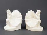 pair of white ceramic figurines of a woman and a man with a fan