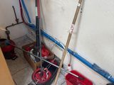 two mops and a bucket on the floor in a room