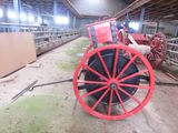 a red wagon that is sitting in a barn