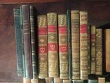 many old books on a shelf in a library