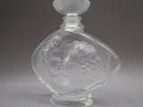 a clear glass bottle with a picture of a woman on it
