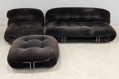 three black chairs and a ottoman in a white room
