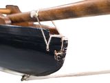 a wooden boat with a wooden paddle on it