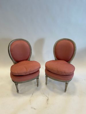 pair of vintage french style chairs with pink upholstered cushions