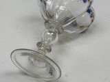 a broken wine glass on a white table