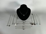 necklaces, bracelets, and necklaces are displayed on a table