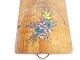 a small wooden box with flowers painted on it