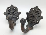 pair of antique cast iron coat hooks with ornate design