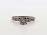 a white gold ring with a diamond center stone and two rows of diamonds