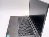 a laptop with a black keyboard on a white surface