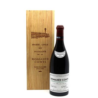 a bottle of wine sitting next to a wooden box
