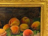 a painting of peaches on a table in a gold frame