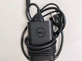 a dell charger that is plugged into the wall