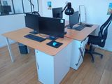 a computer desk with two monitors and a keyboard on it