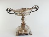 a silver vase that is sitting on a table