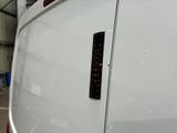 a close up of a white van with a black sticker on it