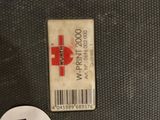 a sticker on the back of a suitcase that has a red cross on it