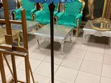 a lamp that is sitting on a stand in a room