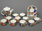 a lot of cups and saucers that are sitting on a table