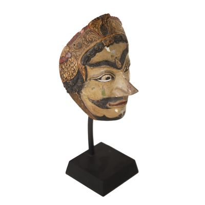 a close up of a wooden mask on a stand on a white background