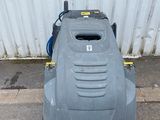 an image of a lawn mower parked on the side of the road