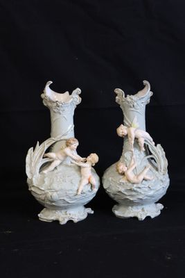 two vases that are sitting on a black surface