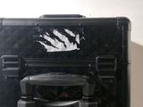 a black suitcase with a hole in it sitting on a table