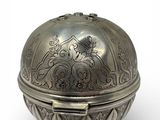 an antique silver box with a decorative design on the lid