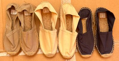 several pairs of shoes are lined up against a wall