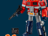 a toy robot that is standing next to a toy gun