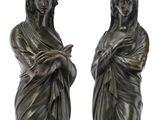 pair of bronze statues of a woman and a man holding hands