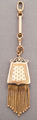 a close up of a gold necklace with a purse on it