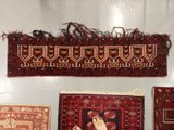 a person standing in front of a display of rugs and rugs