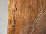 a close up of a piece of wood with writing on it