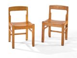 pair of wooden chairs against a white background