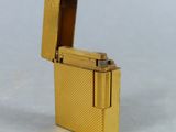 a gold lighter that is sitting on a table