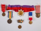 an image of a group of medals and ribbons hanging on a wall