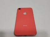 a close up of a red iphone sitting on top of a white table