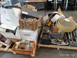 a pile of junk on a pallet in a warehouse