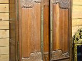 a wooden armoire with a mirror on top of it