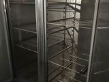 a large stainless steel refrigerator that is open and empty