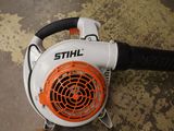 a blower that is sitting on the floor next to a person