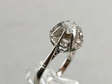 a close up of a diamond ring on top of a clear glass