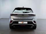 the rear of a silver volvo v - cross parked in a white room