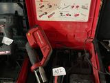 a red tool box with tools in it on the floor
