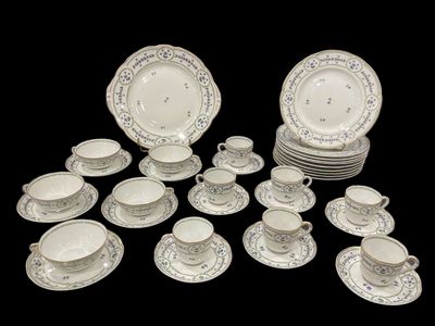 a lot of plates and cups and saucers on the table
