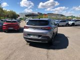 many cars parked in a parking lot with a sky background