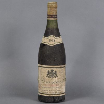 an old bottle of wine sitting on top of a table